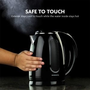 Black electric kettle with steam rising, hand pressing the handle, showcasing modern kitchen appliance safe to touch exterior. Perfect for quick, hot water and energy-efficient boiling.