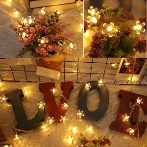 String fairy lights with LED floral bulbs and love-themed decorative letters for cozy, romantic home decor and holiday sale promotions.
