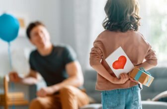 Heart-themed greeting card, gift box, child with love note, birthday celebration, family love, valentines day, special occasion, indoor event, warmhearted gesture, Gift Giving, Family Bonding.