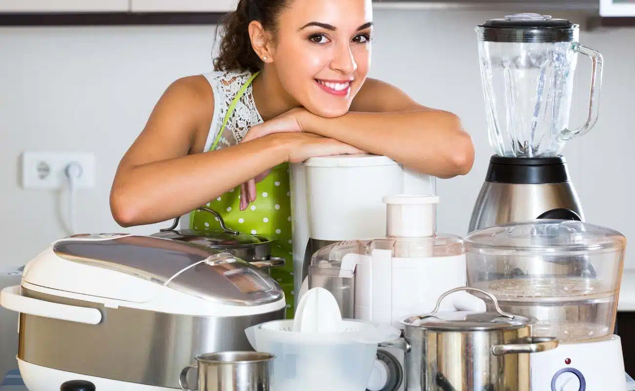 Bright smiling woman with kitchen appliances for healthy cooking, focusing on home culinary essentials for sale.