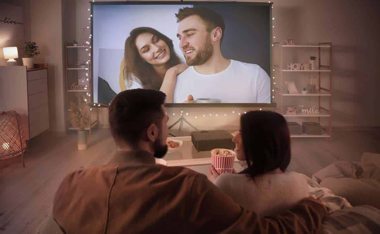 Family watching a movie on home theater system during sale is live event, cozy living room with snacks and ambient lighting, enjoying a romantic or family movie night at home.