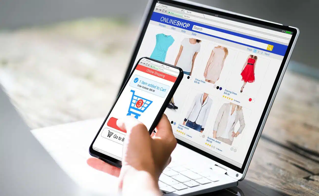 Online shopping on laptop and smartphone showcasing sale items at Sale is Live, highlighting deals and discounts on fashion apparel and accessories for a seamless e-commerce experience.