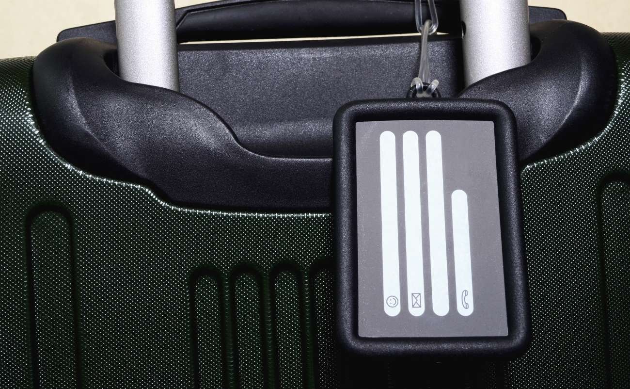 Luggage handle with RFID block tag attached, secure travel identification anti-theft protection.
