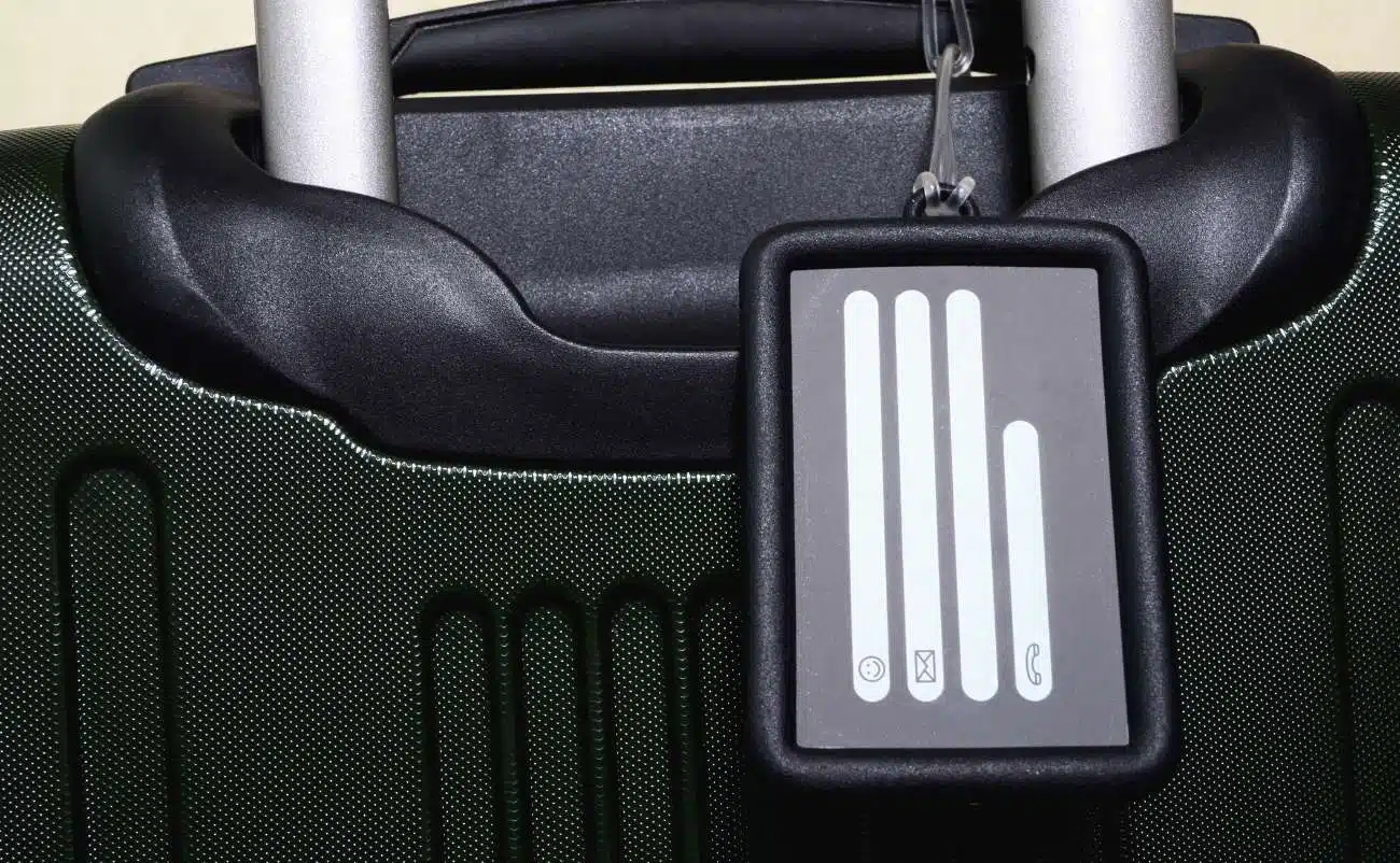 Luggage handle with RFID block tag attached, secure travel identification anti-theft protection.