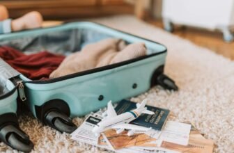 Bag with clothes and travel accessories on the carpet, ready for the trip, featuring a miniature airplane, passport, and travel documents for a seamless travel experience.