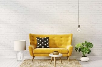 Yellow velvet mid-century sofa with black polka dot pillow in modern living room.