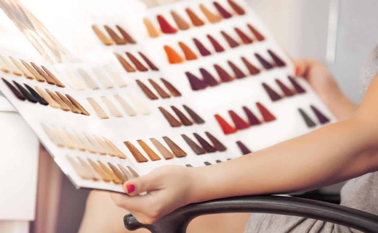 Color swatch sample sheet showing various shades of lipstick or paint for sale at a promotional sale event.