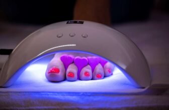 Gel nail curing lamp with purple LED lights for professional manicures, fast drying, and high-quality nail polish application.
