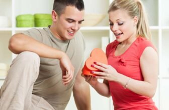 Beautiful young couple exchanging a heartfelt gift during Sale is Live shopping event, celebrating love and special moments.