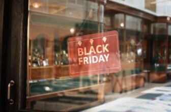 Black Friday sale sign on store window promoting shopping discounts and deals.