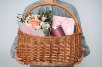Beautiful gift basket with fresh flowers, wrapped presents, and a coffee tumbler, perfect for special occasions or celebrations. Sale is Live offers great gift ideas and shopping deals.
