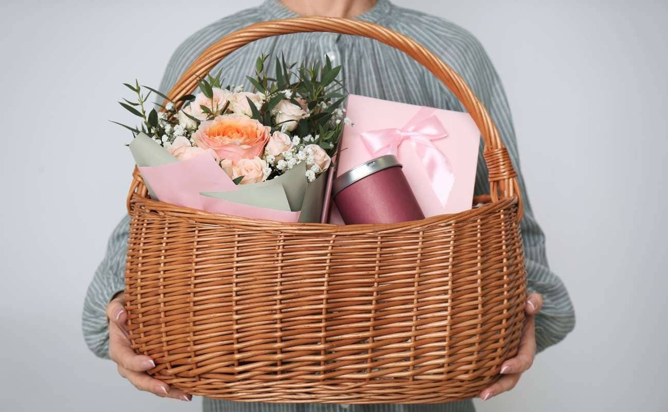 Beautiful gift basket with fresh flowers, wrapped presents, and a coffee tumbler, perfect for special occasions or celebrations. Sale is Live offers great gift ideas and shopping deals.