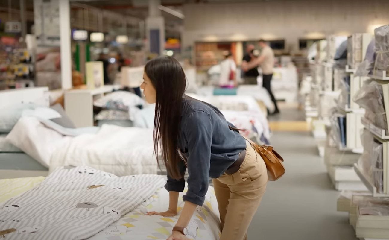 Bed linens and mattresses on sale at a home goods store during a clearance event.