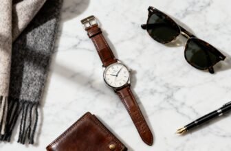 Sleek leather strap watch, stylish sunglasses, fountain pen, and wallet on marble surface for men's fashion and accessories. Perfect for stylish, luxurious accessories shopping.