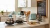 Modern kitchen countertop with cookware, utensils, and small appliances, showcasing budget-friendly kitchen essentials for efficient meal preparation.