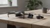 Quality drone with camera, remote control, and accessories displayed on a wooden table in a bright, modern office environment. Perfect for aerial photography and videography.